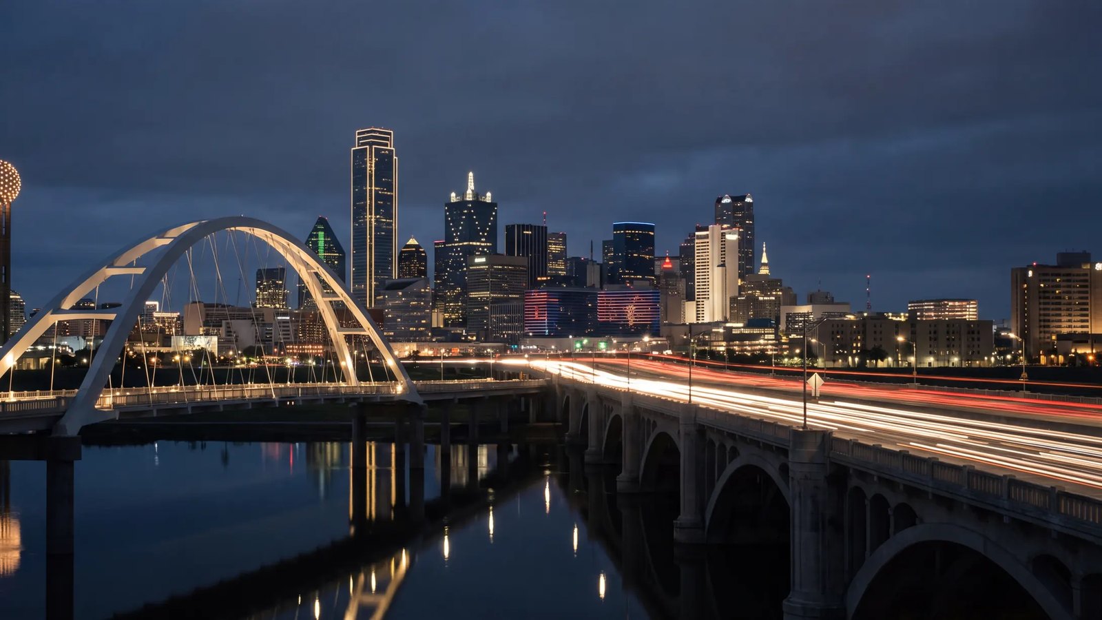 The Dallas skyline at dusk with Reunion Tower and the Margaret McDermott Bridge over the Trinity River